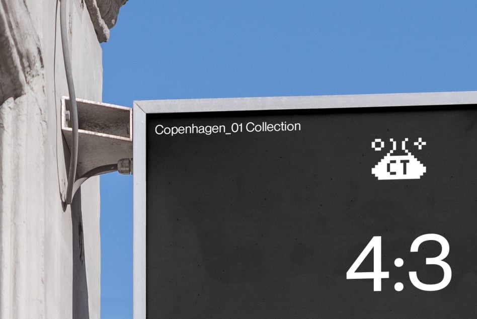 Vertical signage mounted on building exterior with clear blue sky backdrop